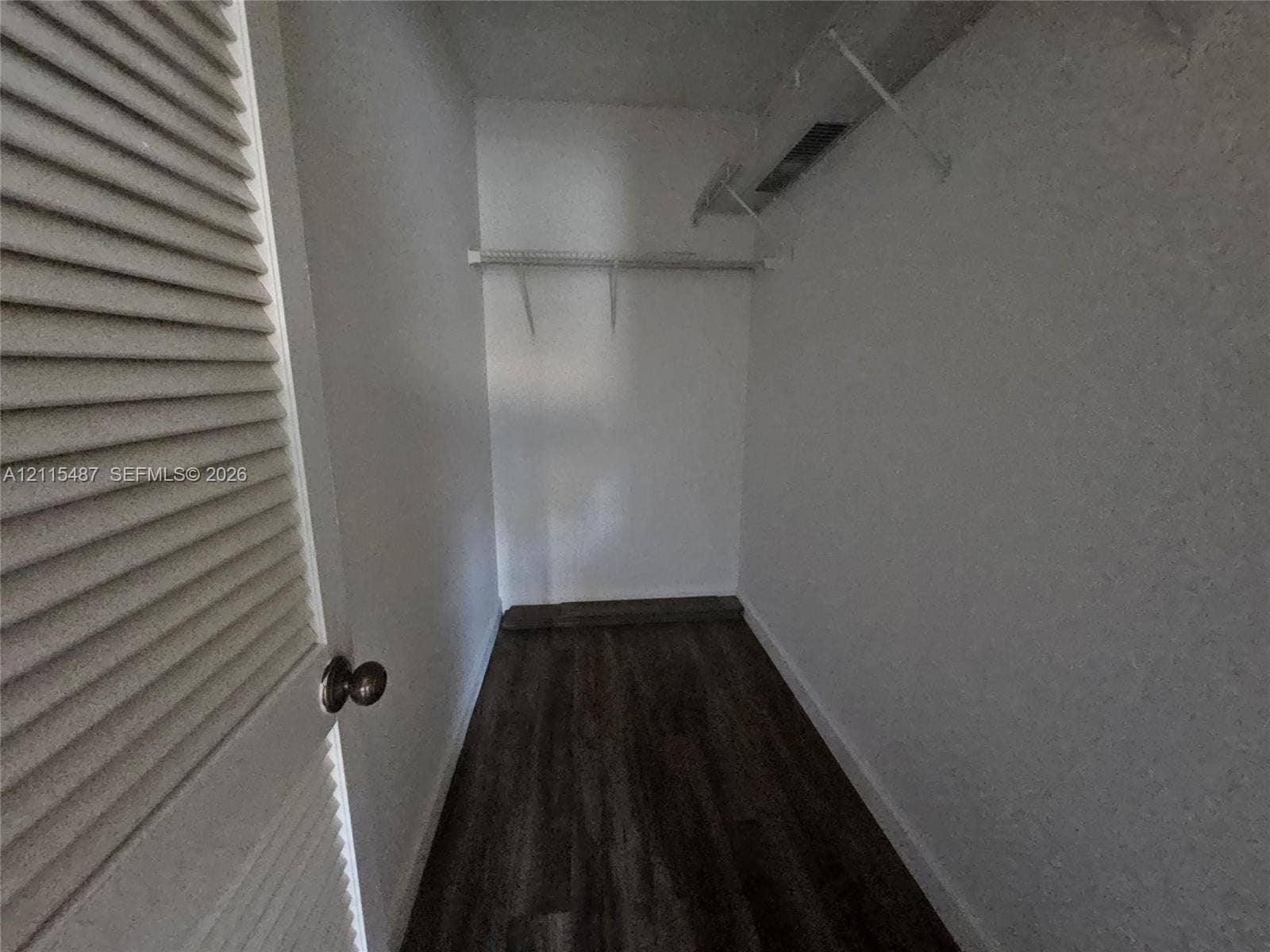 4279 NW 89th Avenue, #205, Coral Springs, Coral Springs, FL 33065 Walk-in closet featuring wood-finish flooring, white walls, and built-in white wire shelving