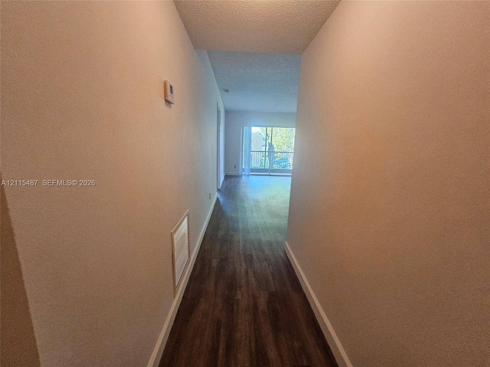 4279 NW 89th Avenue, #205, Coral Springs, Coral Springs, FL 33065 Hallway featuring wood-finish flooring and sliding glass doors