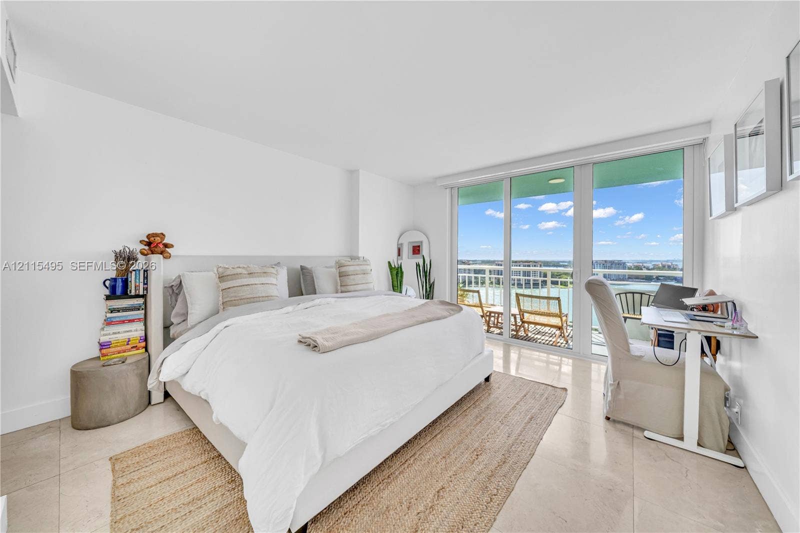 Floor-to-ceiling glass sliding doors, private balcony, polished stone flooring, and expansive windows