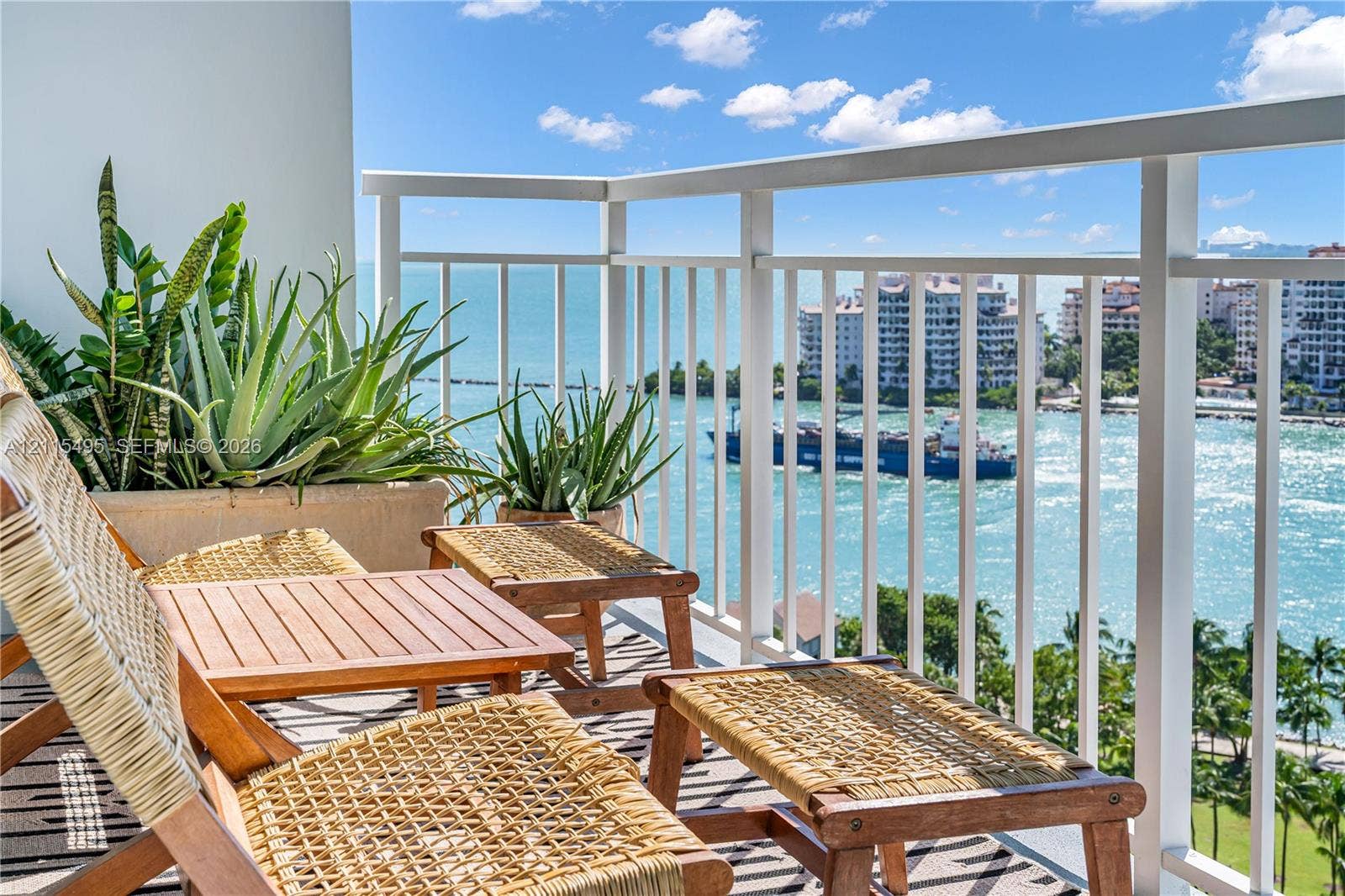 Private balcony featuring a white metal railing and open water exposure