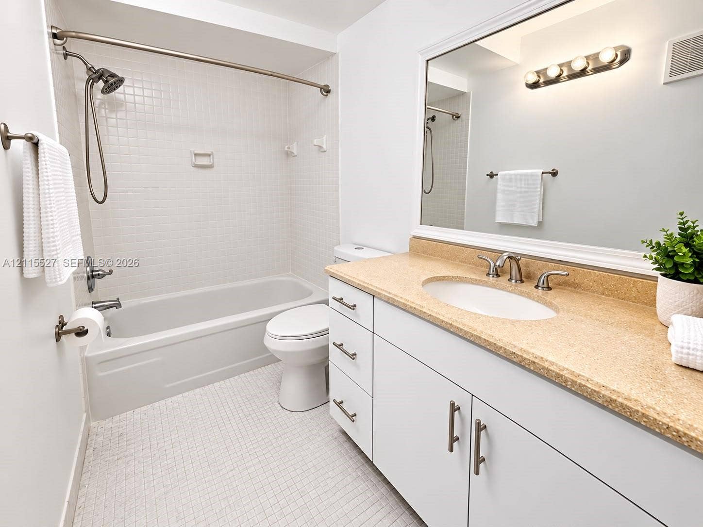 220 Lakeview Drive, #101, Weston, Weston, FL 33326 Bathroom featuring a white vanity with integrated oval sink, textured stone-finish countertop, brushed nickel hardware, and a tub-shower combination with square wall tile