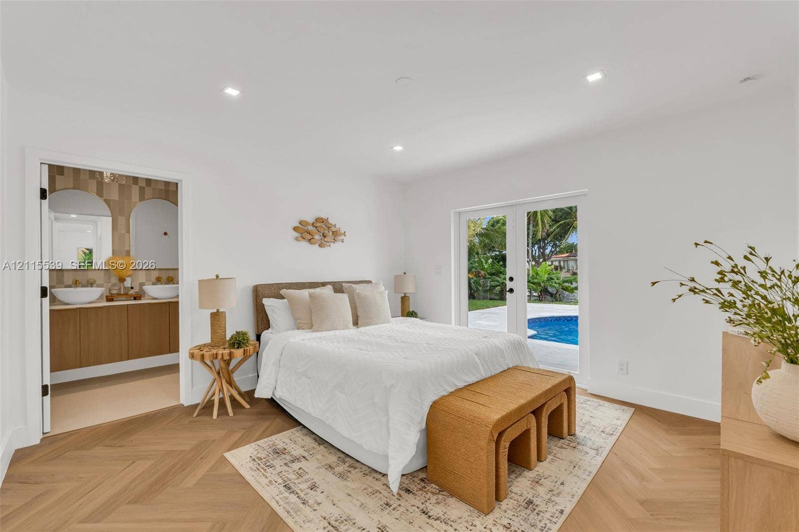381 SE 6th Terrace, Pompano Beach, FL 33060 Herringbone-patterned wood-finish flooring, recessed lighting, and glass-paned double doors with exterior pool access