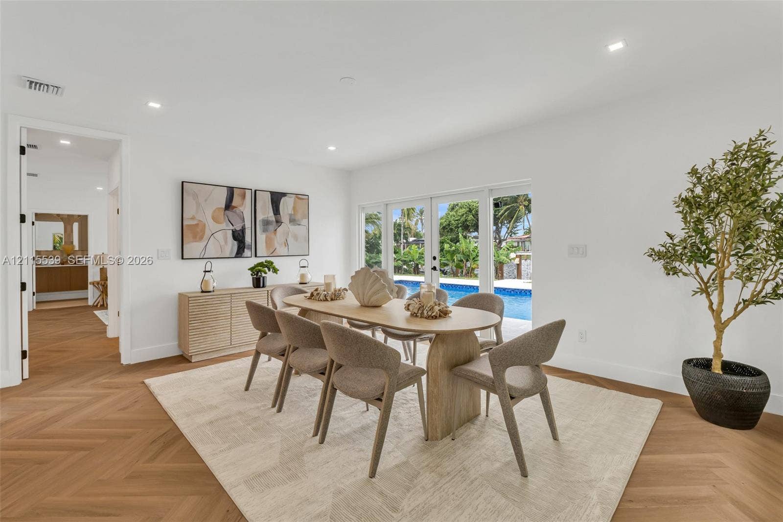 381 SE 6th Terrace, Pompano Beach, FL 33060 Herringbone-pattern wood-finish flooring, recessed lighting, and multi-panel glass exterior doors