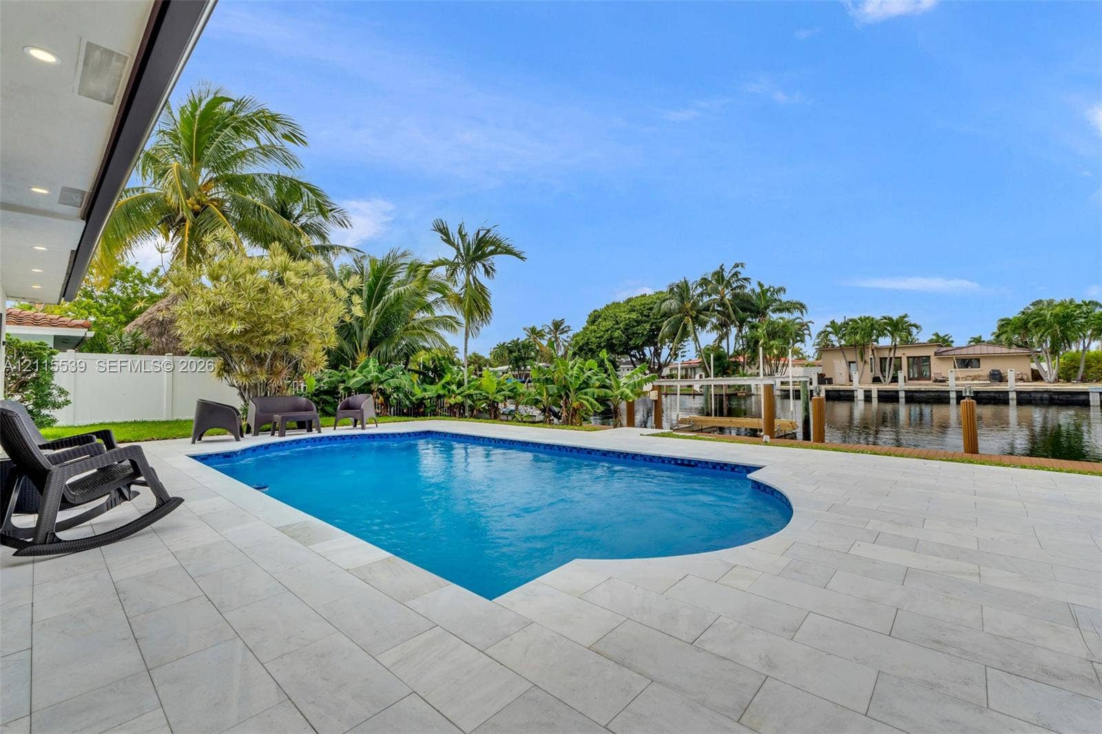 381 SE 6th Terrace, Pompano Beach, FL 33060 Inground swimming pool with tiled surround, concrete patio, and direct waterfront access via a private dock