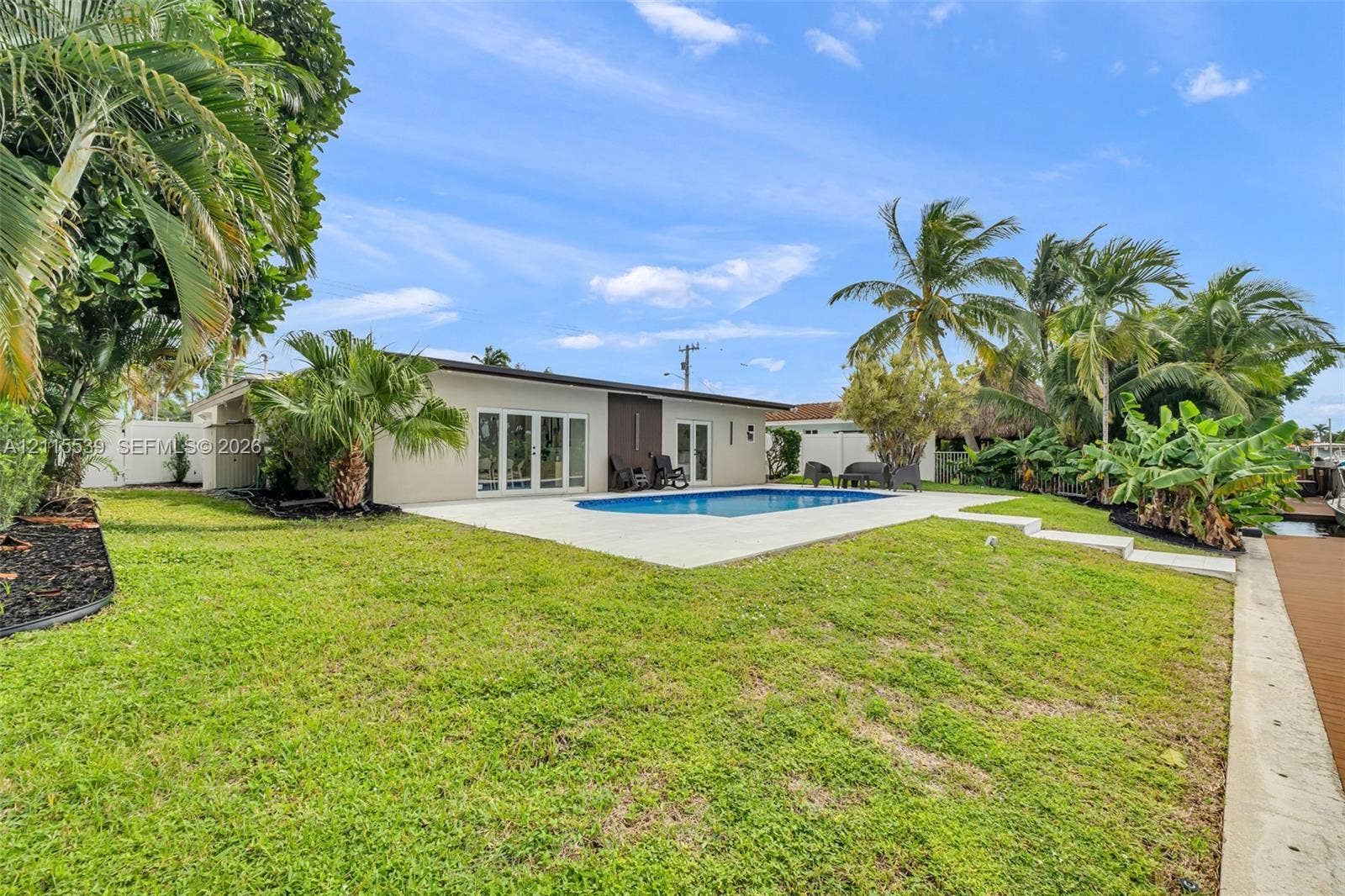 381 SE 6th Terrace, Pompano Beach, FL 33060 Dual sliding Shaker-style doors with a matte white finish and herringbone wood-finish flooring