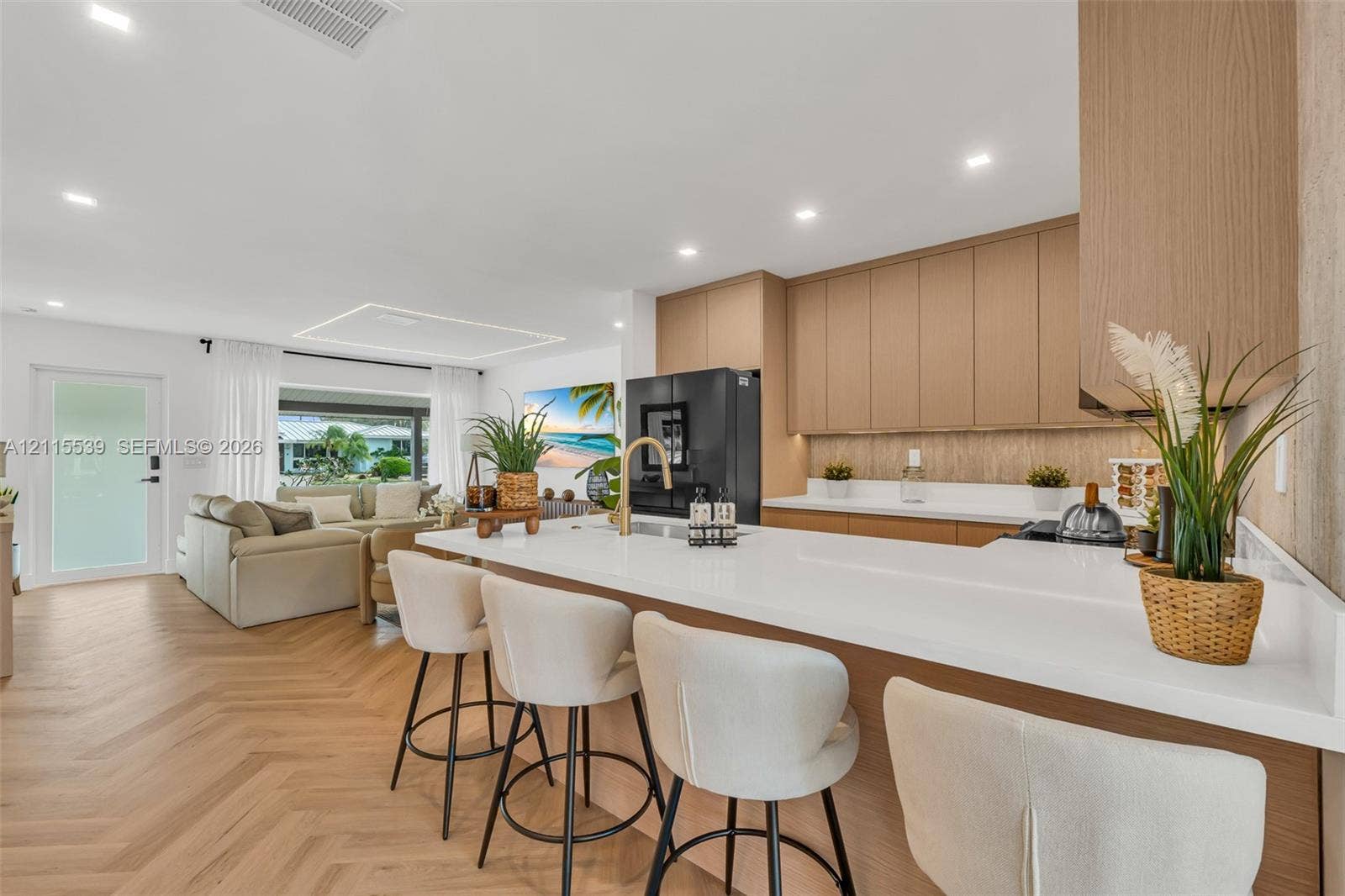 381 SE 6th Terrace, Pompano Beach, FL 33060 Kitchen featuring flat-panel wood cabinetry, white countertops, a gold-toned faucet, herringbone wood-finish flooring, and recessed ceiling lighting