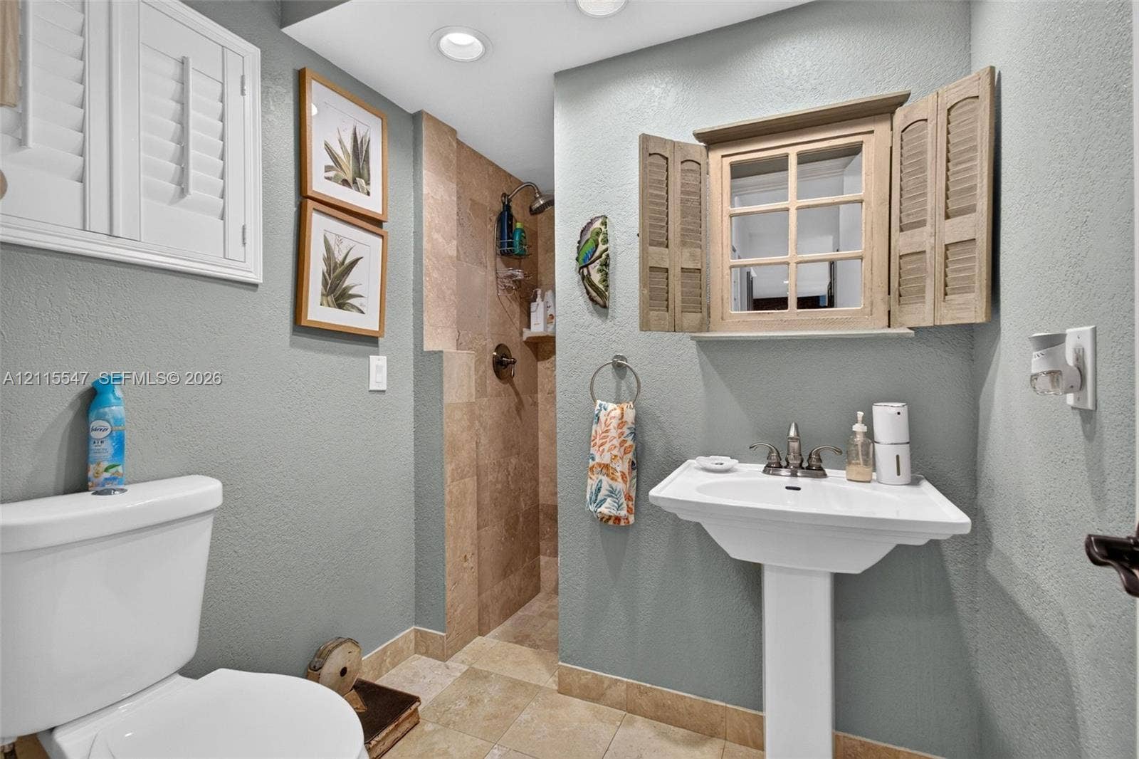22862 Ironwedge Drive, #0, Boca Raton, FL 33433 Pedestal sink with metal faucet, tile-surround walk-in shower, stone-finish flooring, and recessed ceiling lighting