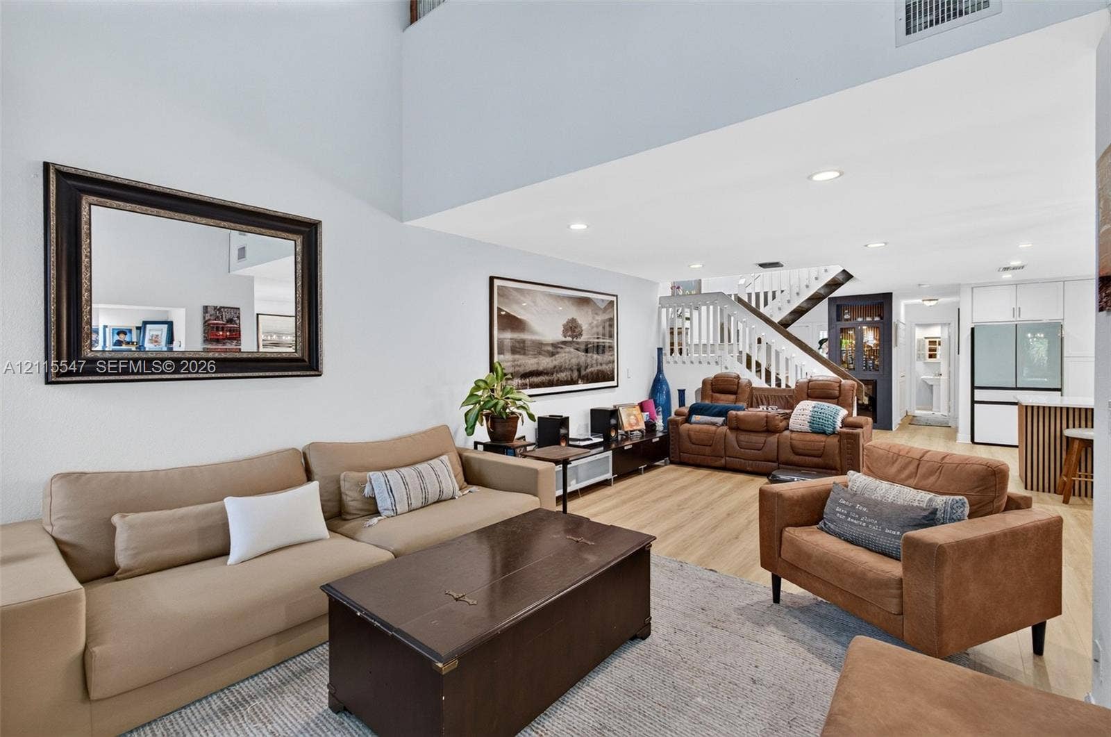 22862 Ironwedge Drive, #0, Boca Raton, FL 33433 Double-height ceilings, wood-finish flooring, recessed lighting, and a staircase featuring a white balustrade with a wood handrail
