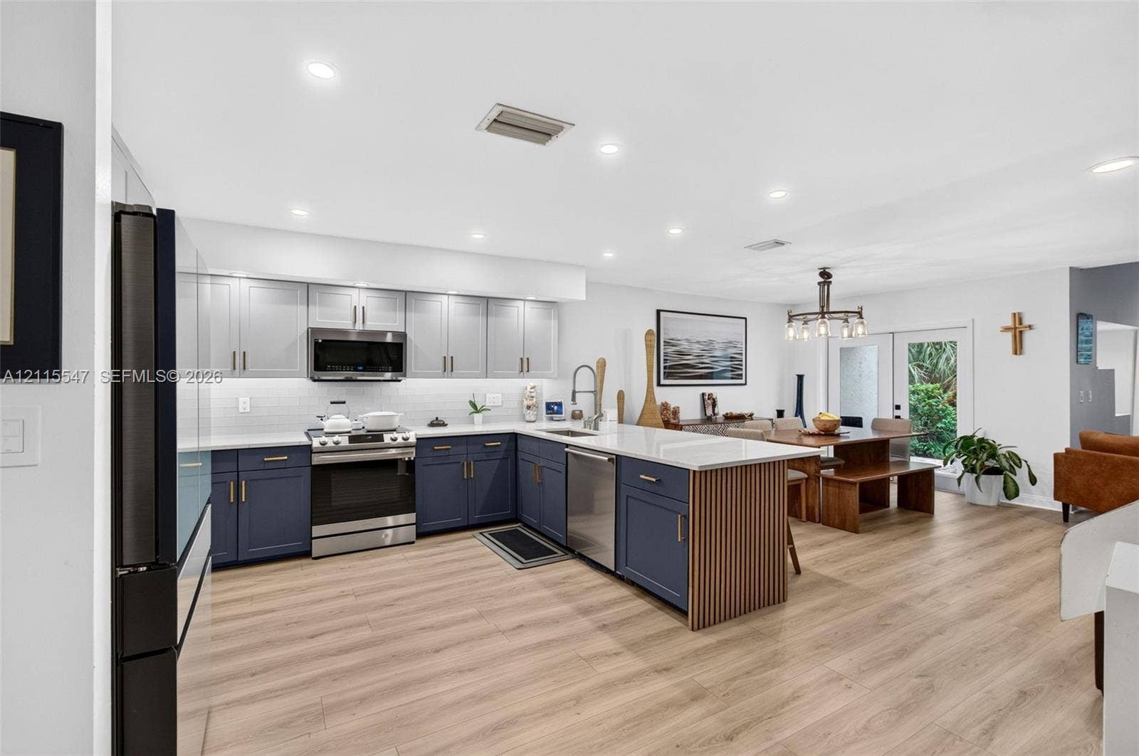 22862 Ironwedge Drive, #0, Boca Raton, FL 33433 Kitchen featuring two-tone cabinetry, wood-finish flooring, quartz countertops, a slatted wood kitchen island accent, and recessed lighting