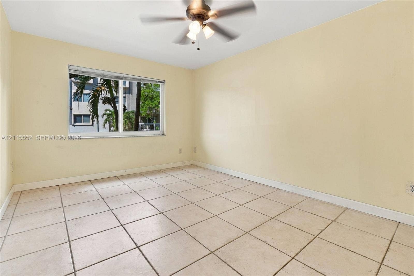 7805 Camino Real, #H-220, Miami, FL 33143 Neutral-toned ceramic tile flooring, horizontal sliding window, and central ceiling fan with integrated light fixture