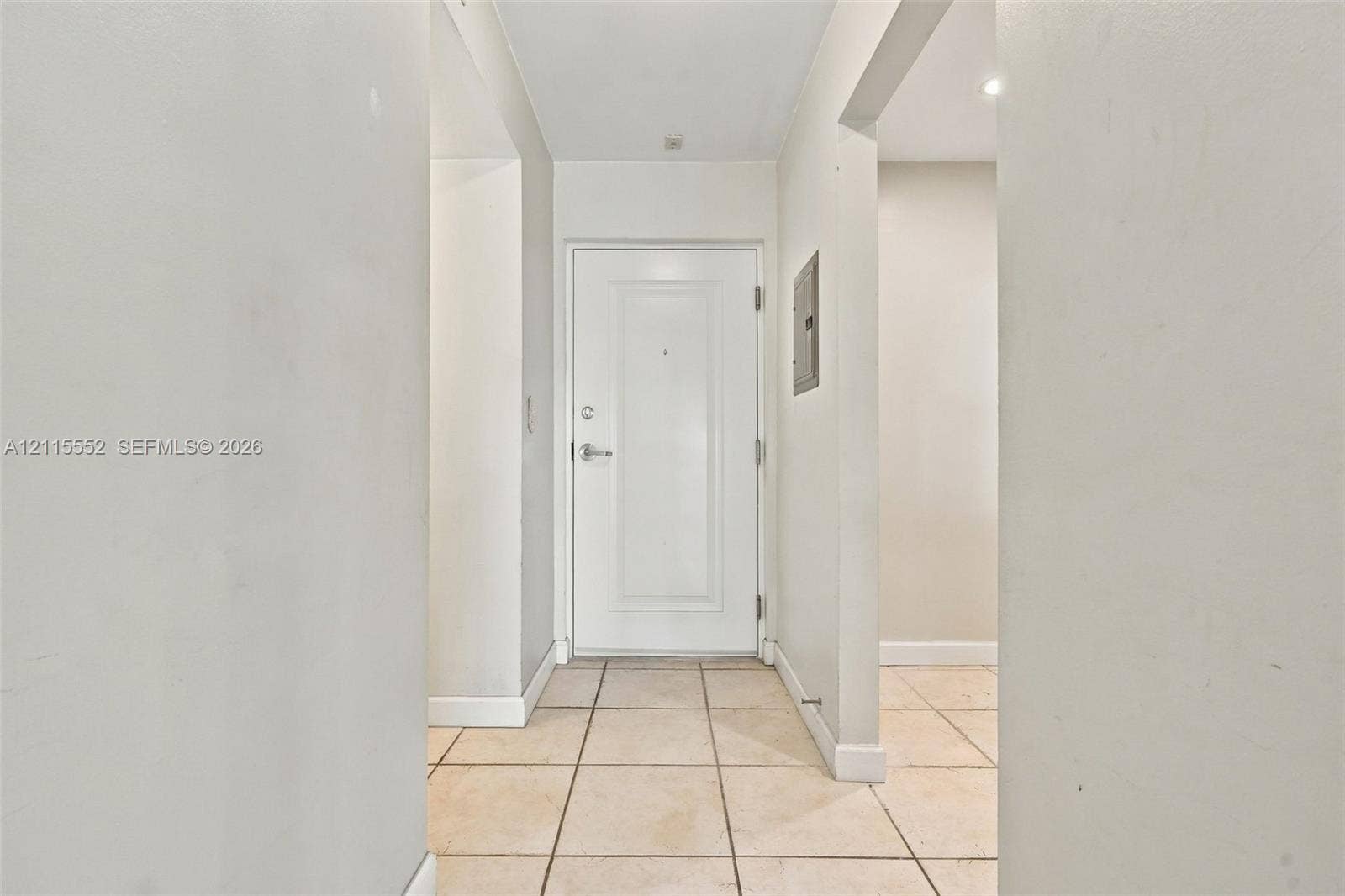 7805 Camino Real, #H-220, Miami, FL 33143 Entryway featuring a white paneled door with brushed metallic hardware and light-toned ceramic tile flooring