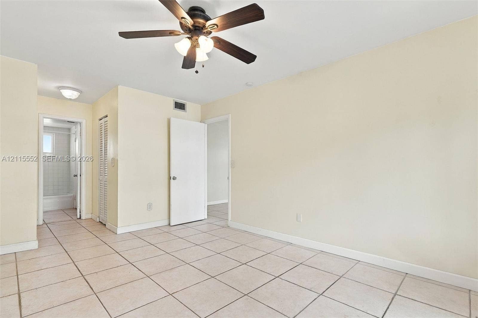 7805 Camino Real, #H-220, Miami, FL 33143 Neutral tile flooring, ceiling fan with integrated lighting, and louvered closet doors