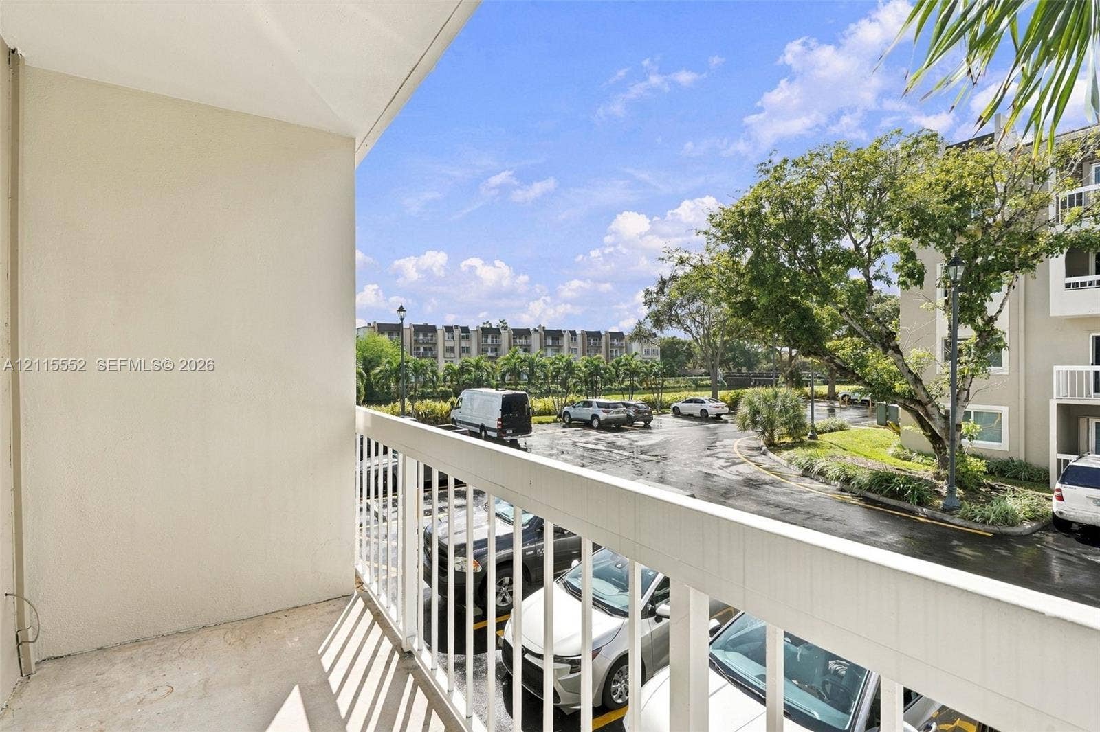 7805 Camino Real, #H-220, Miami, FL 33143 Private balcony featuring white metal railing, solid surface flooring, and smooth-finish walls