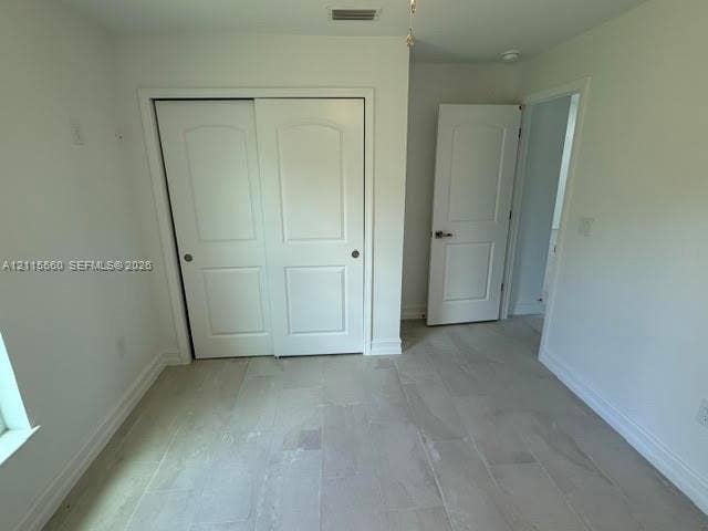 105 Concord Loop, Labelle, FL 33935 Neutral-toned tile flooring, two-panel interior doors, and closet with sliding panel doors