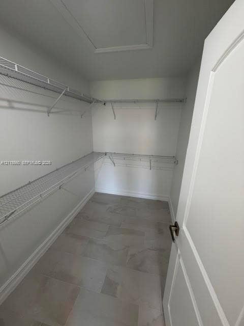 105 Concord Loop, Labelle, FL 33935 Storage space featuring large-format ceramic tile flooring and wrap-around white wire shelving