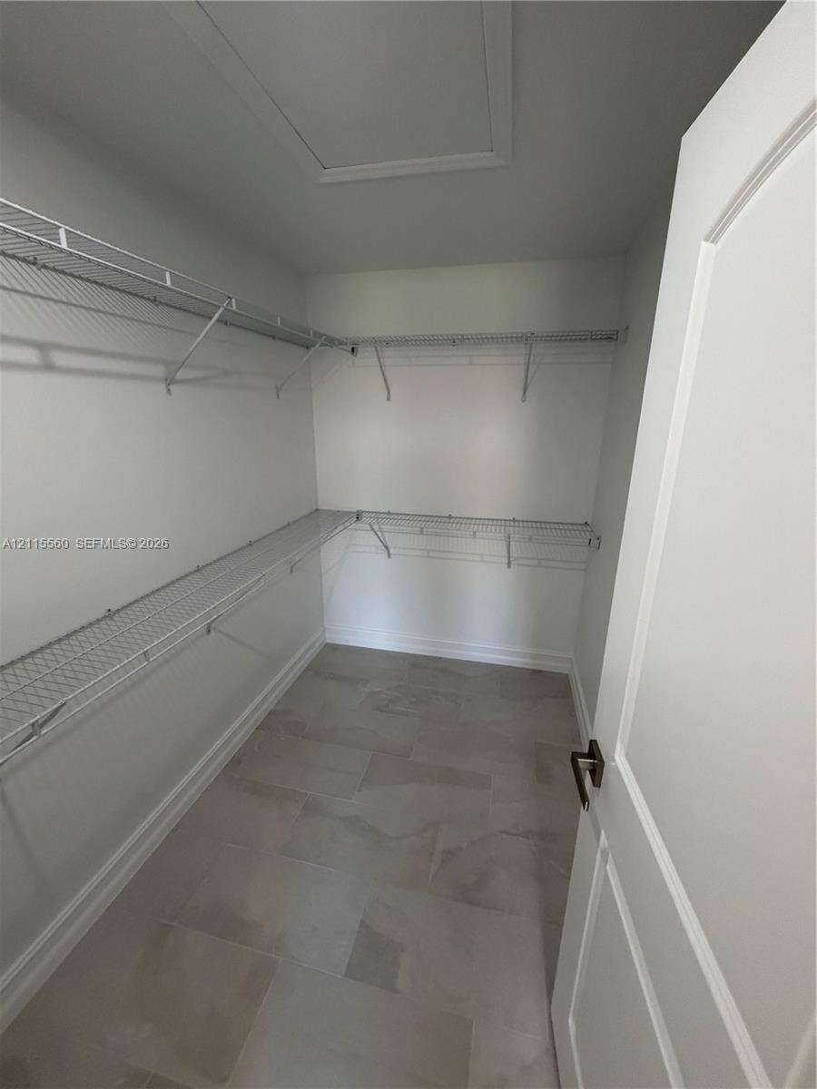 105 Concord Loop, Labelle, FL 33935 Walk-in storage space featuring multi-level wire shelving and large-format tile flooring