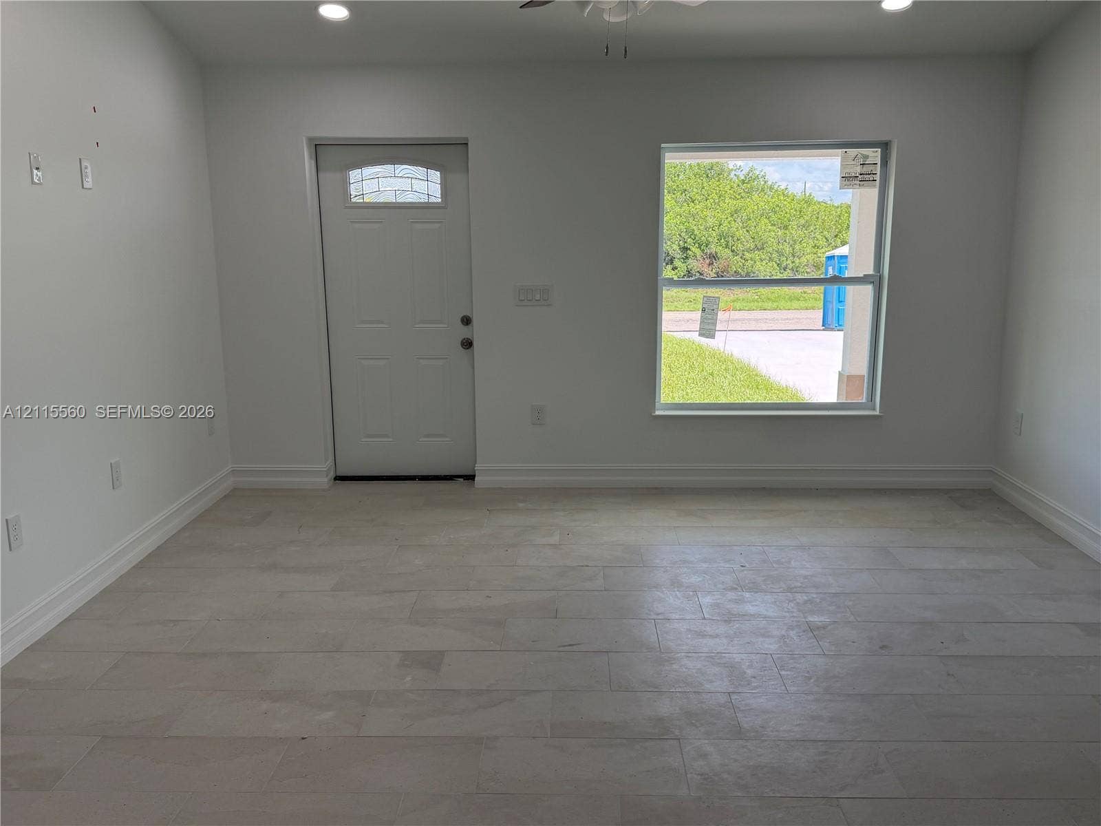 105 Concord Loop, Labelle, FL 33935 Neutral-toned tile flooring, recessed ceiling lighting, and a single-light glass panel entry door
