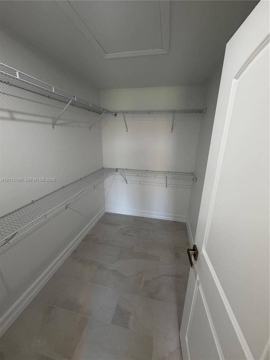 105 Concord Loop, Labelle, FL 33935 Storage room featuring large-format ceramic tile flooring and multi-level white wire shelving