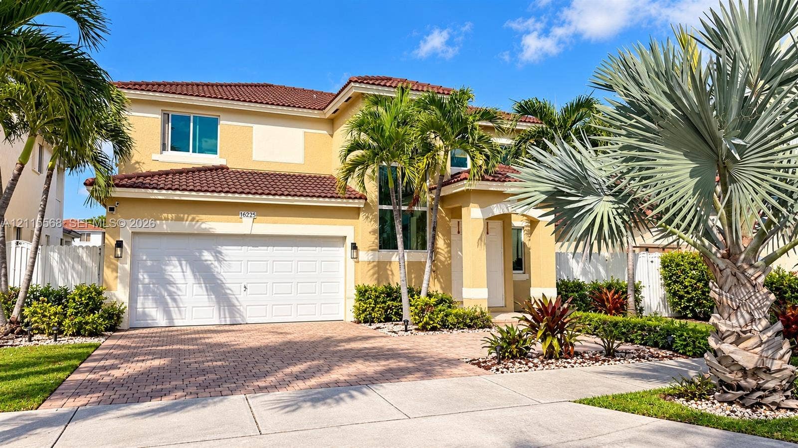 16225 SW 61st Lane, Miami, FL 33193 Two-story stucco exterior featuring a tiled roof, multi-car garage, and paver driveway