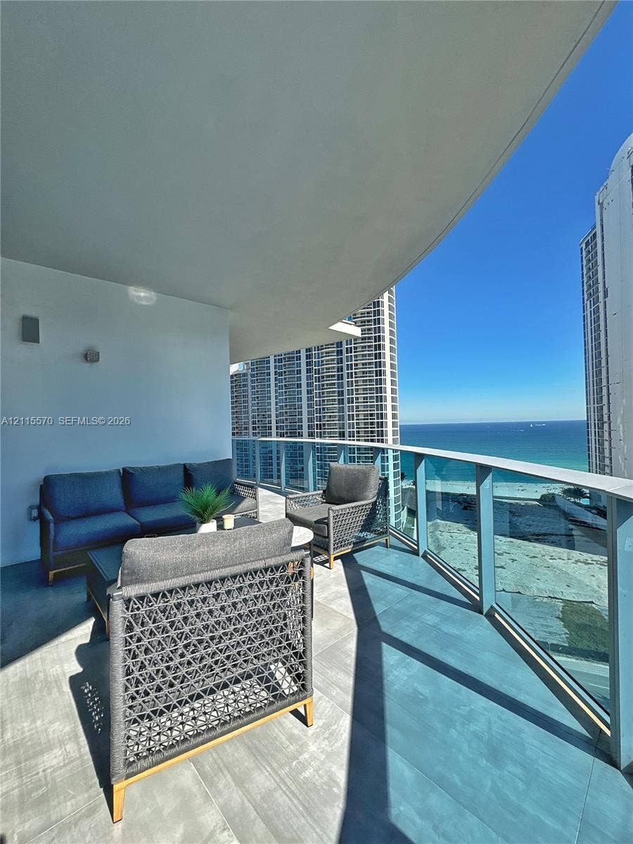 17550 Collins Avenue, #1401, Sunny Isles Beach, Sunny Isles Beach, FL 33160 Private balcony featuring large-format tile flooring and a glass railing system
