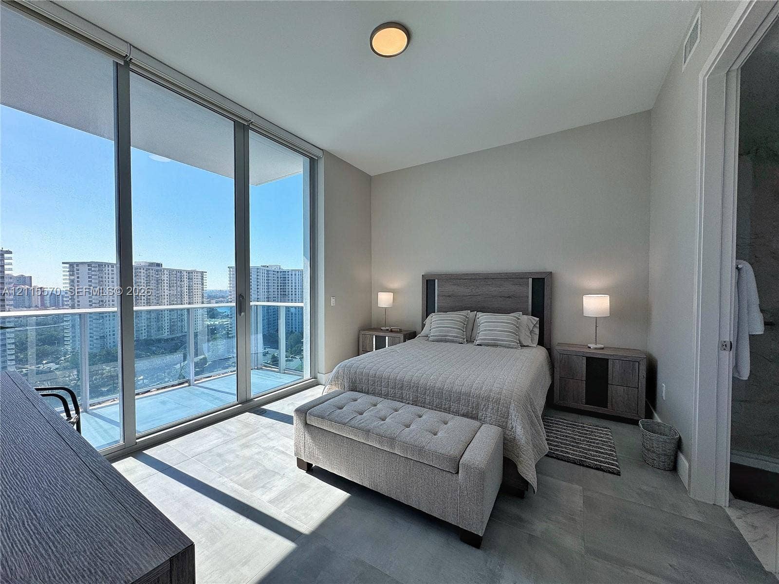 17550 Collins Avenue, #1401, Sunny Isles Beach, Sunny Isles Beach, FL 33160 Floor-to-ceiling windows, private balcony, neutral-tone tile flooring, and flush-mount ceiling lighting