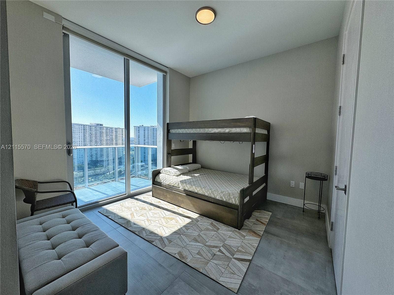 17550 Collins Avenue, #1401, Sunny Isles Beach, Sunny Isles Beach, FL 33160 Floor-to-ceiling windows, access to a glass-railed balcony, and large-format tile flooring