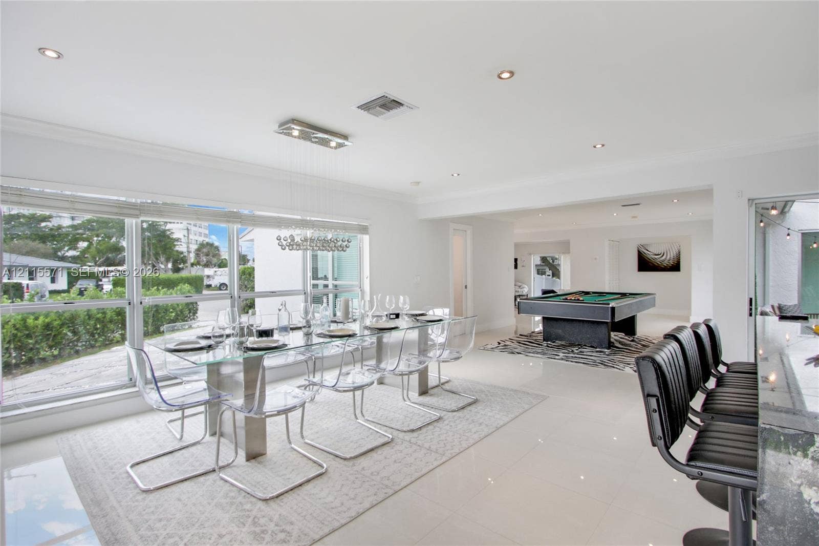 2001 NE 122nd Road, North Miami, FL 33181 Open-concept floor plan featuring polished tile flooring, recessed lighting, crown molding, and floor-to-ceiling windows