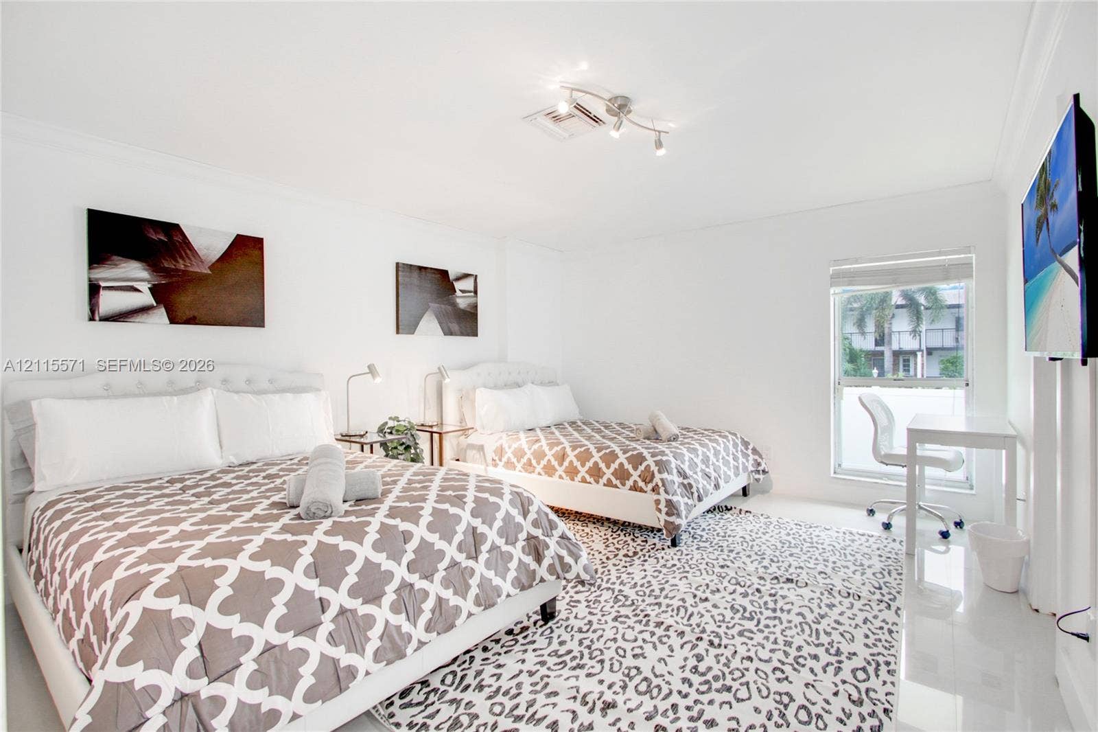 2001 NE 122nd Road, North Miami, FL 33181 High-gloss tile flooring, crown molding, and a multi-directional adjustable track lighting fixture