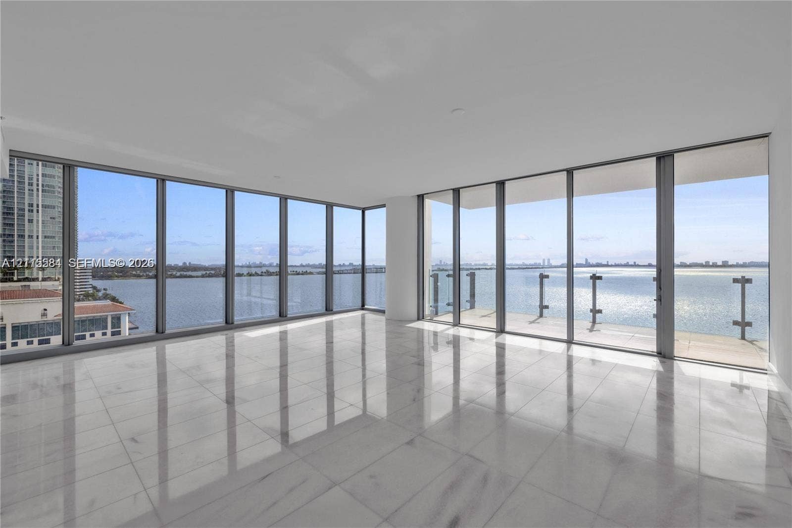 700 NE 26th Terrace, #901, Miami, Miami, FL 33137 Floor-to-ceiling windows, wrap-around glass balcony railing, expansive stone tile flooring, and panoramic water exposure
