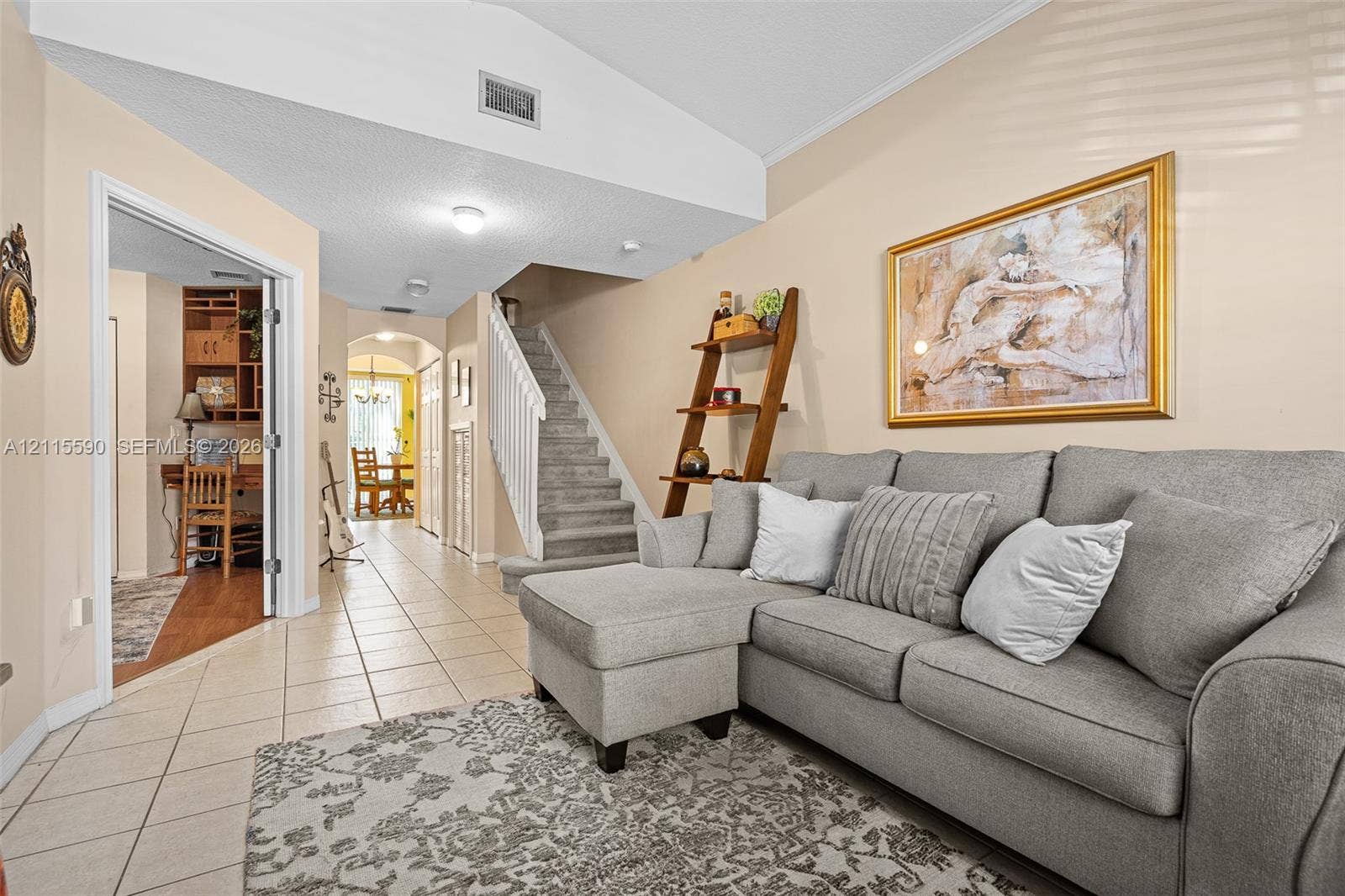 4948 Tradewinds Terrace, #504, Dania Beach, FL 33312 Vaulted ceiling, ceramic tile flooring, and carpeted staircase with white balusters