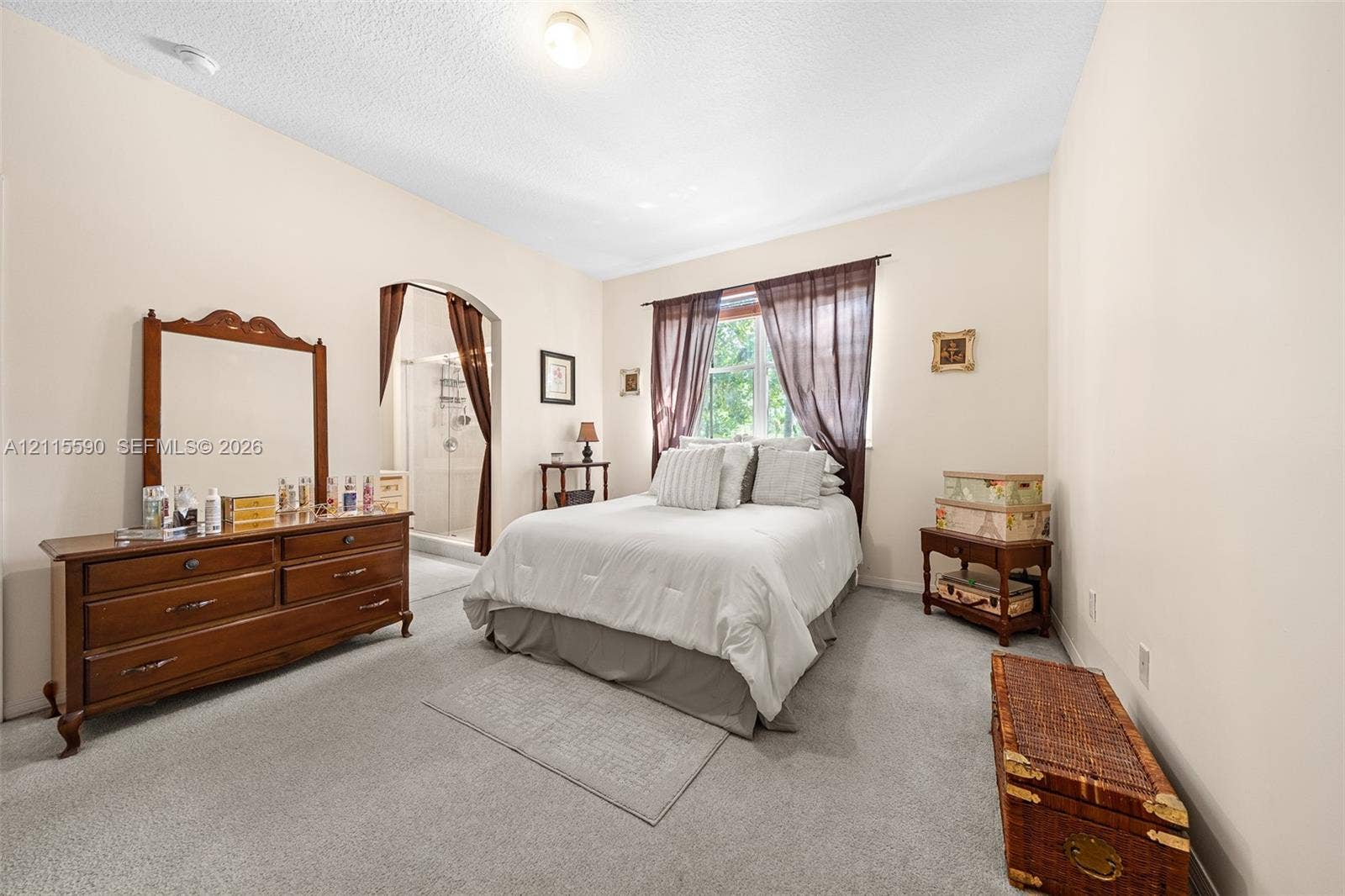 4948 Tradewinds Terrace, #504, Dania Beach, FL 33312 Room featuring neutral wall tones, wall-to-wall carpeting, an arched doorway, and a window with wood-frame trim