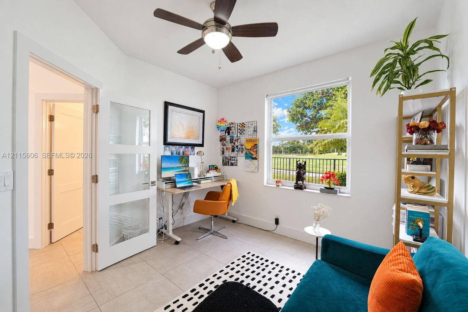 2652 Palmer Place, #2652, Weston, Weston, FL 33332 Neutral-toned tile flooring, three-panel glass-inset interior door, ceiling-mounted light fixture with fan, and a single-hung window