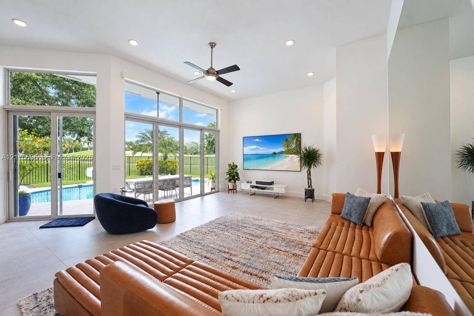 2652 Palmer Place, #2652, Weston, Weston, FL 33332 Expansive living area featuring vaulted ceilings, oversized floor-to-ceiling windows, porcelain tile flooring, recessed lighting, and a modern ceiling fan