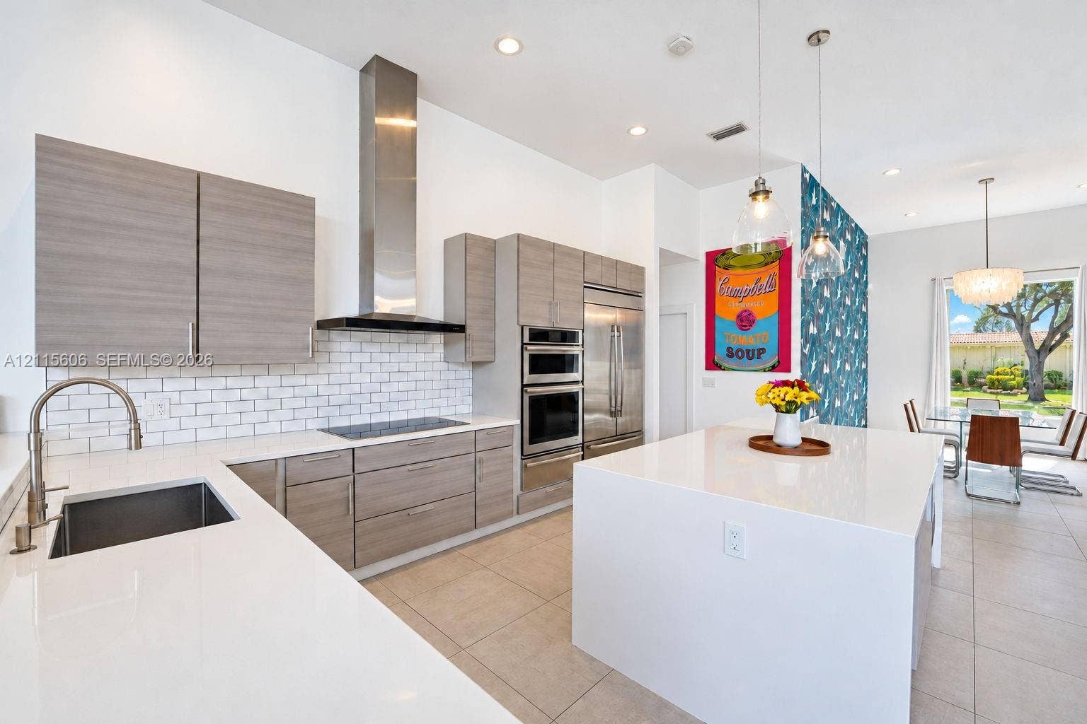 2652 Palmer Place, #2652, Weston, Weston, FL 33332 Kitchen featuring flat-panel wood-finish cabinetry, white countertops, a stainless steel chimney-style range hood, subway tile backsplash, and a large center island
