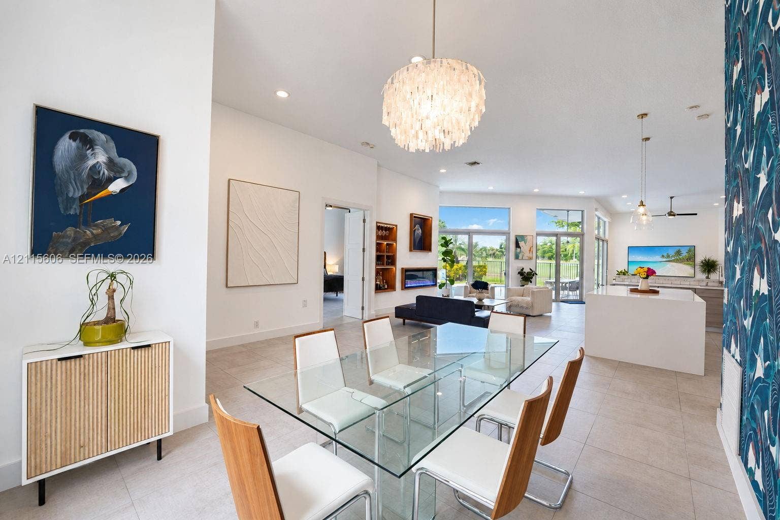 2652 Palmer Place, #2652, Weston, Weston, FL 33332 Open-concept interior featuring high ceilings, large-format tile flooring, recessed lighting, a built-in linear fireplace, and expansive glass doors