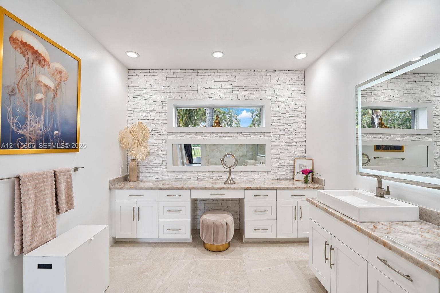 2652 Palmer Place, #2652, Weston, Weston, FL 33332 Stone-veneer feature wall with stacked horizontal windows, white cabinetry with integrated vanity, rectangular vessel sink, and illuminated vanity mirror