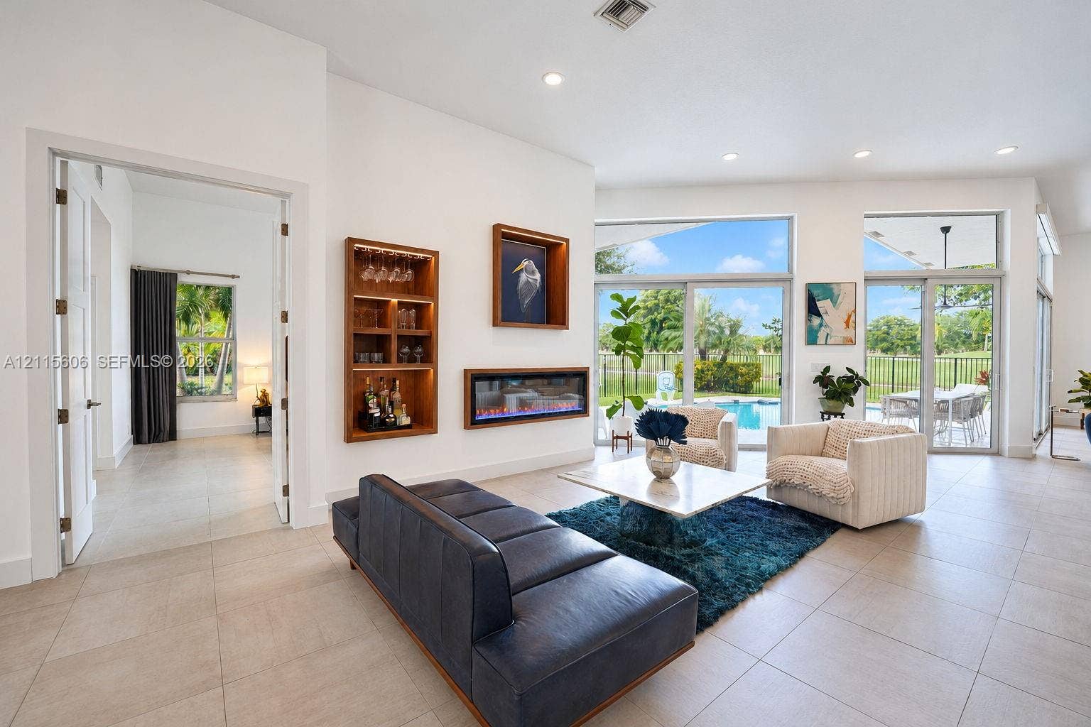 2652 Palmer Place, #2652, Weston, Weston, FL 33332 Living area featuring large-format tile flooring, recessed lighting, a linear electric fireplace, and floor-to-ceiling glass sliding doors