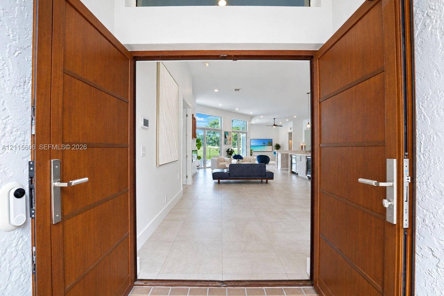 2652 Palmer Place, #2652, Weston, Weston, FL 33332 Double wood-finish entry doors featuring horizontal paneling and brushed metal hardware, complemented by a transom window and large-format tile flooring