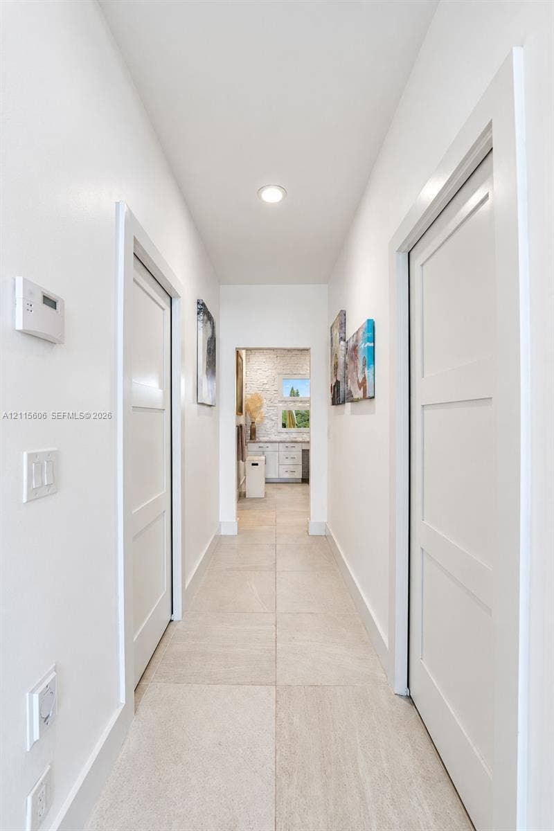 2652 Palmer Place, #2652, Weston, Weston, FL 33332 Hallway featuring large-format tile flooring, three-panel interior doors, and recessed lighting