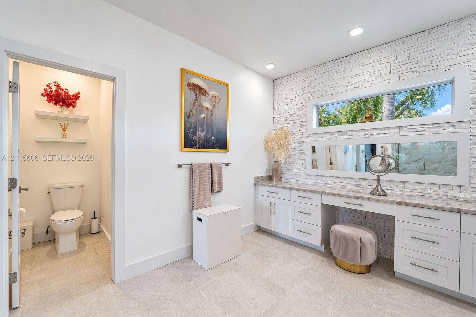 2652 Palmer Place, #2652, Weston, Weston, FL 33332 Textured stone accent wall featuring horizontal ribbon windows, white shaker-style cabinetry with neutral stone countertops, and tile flooring