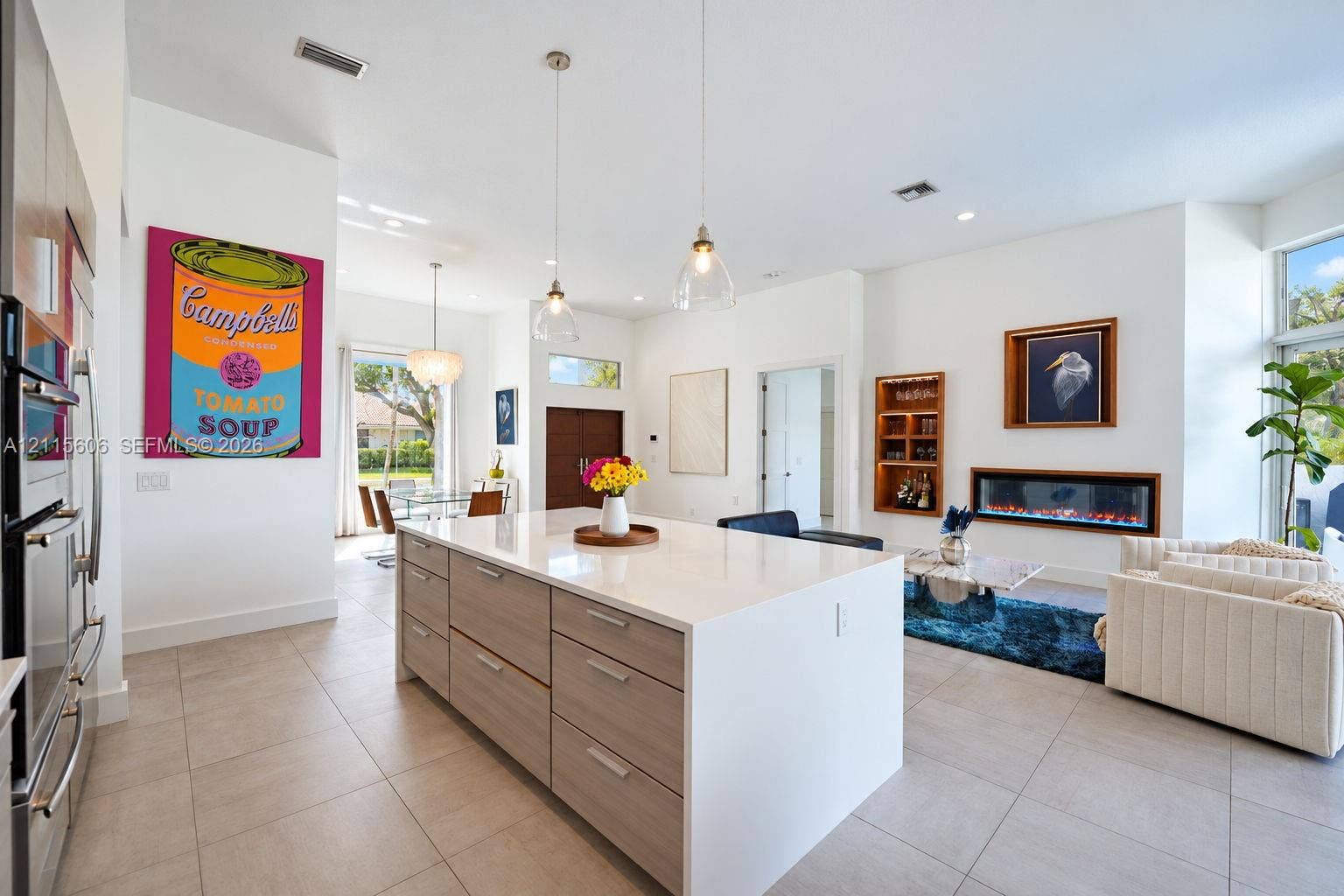 2652 Palmer Place, #2652, Weston, Weston, FL 33332 Large kitchen island with a neutral-toned countertop and wood-finish cabinetry, linear built-in fireplace, recessed lighting, and tile flooring
