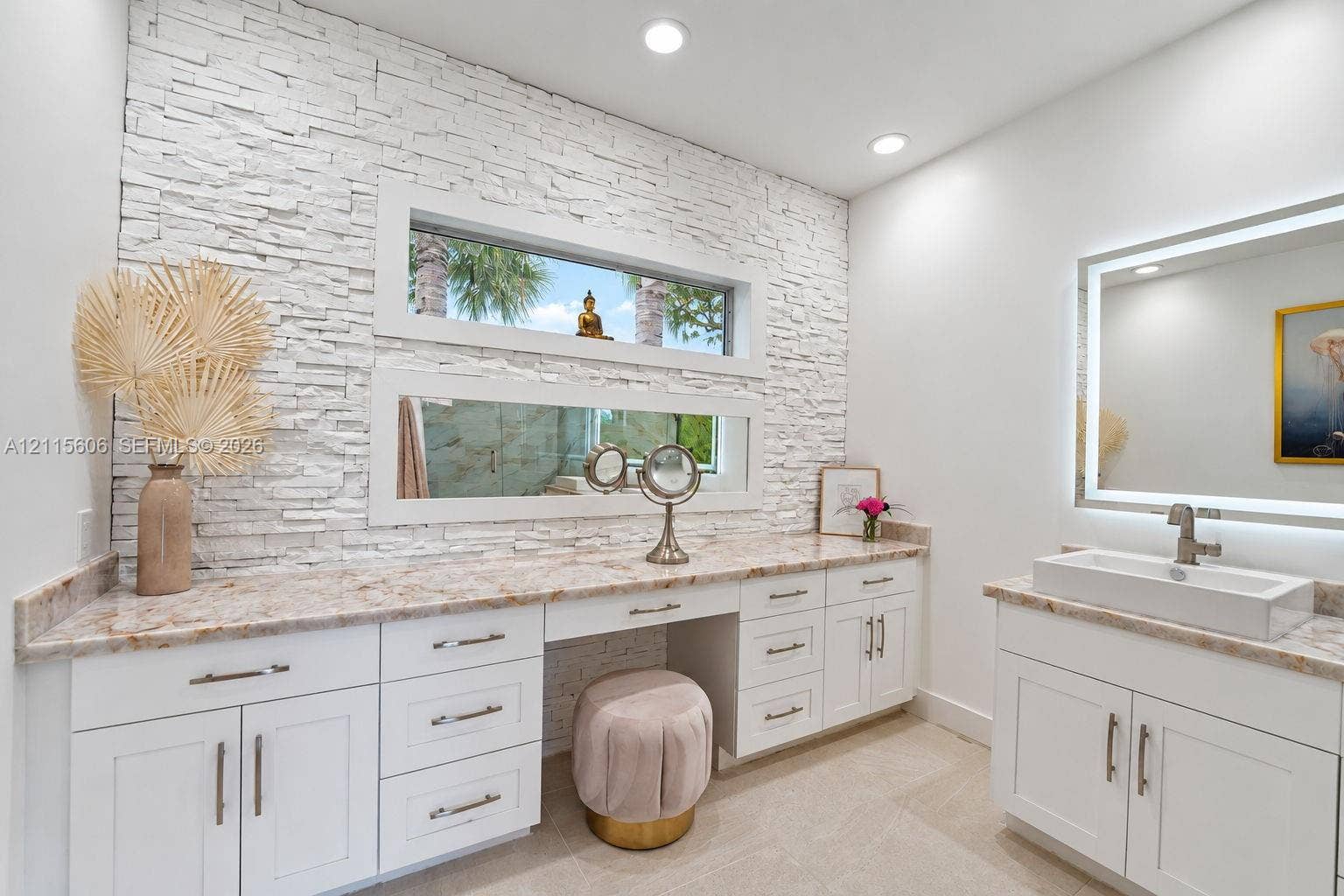2652 Palmer Place, #2652, Weston, Weston, FL 33332 Stacked stone accent wall featuring dual horizontal windows, custom white cabinetry, stone-finish countertops, and a rectangular vessel sink with a wall-mounted faucet