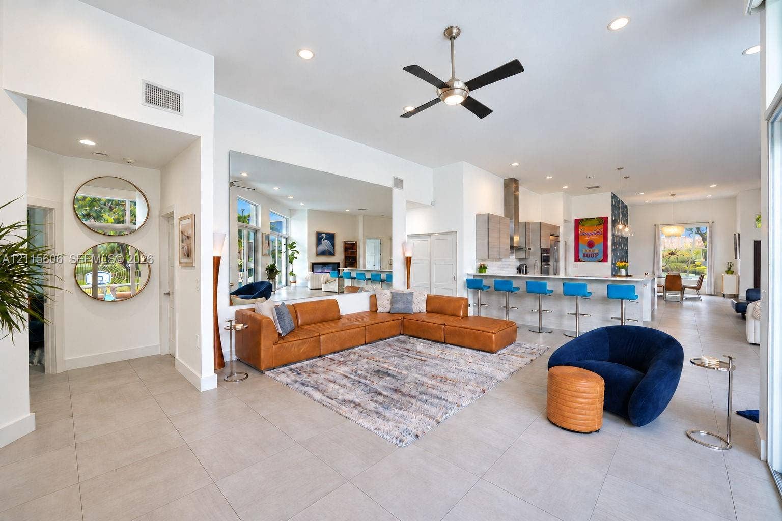 2652 Palmer Place, #2652, Weston, Weston, FL 33332 Open-concept interior featuring large-format tile flooring, recessed ceiling lighting, a contemporary ceiling fan, and a kitchen island with integrated seating