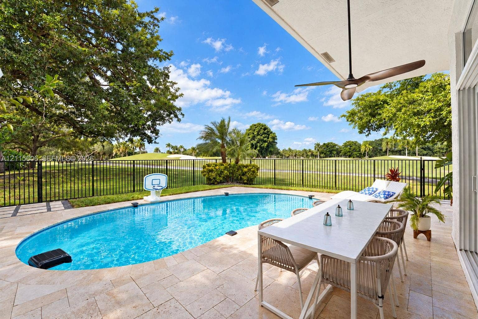2652 Palmer Place, #2652, Weston, Weston, FL 33332 Covered patio featuring a ceiling fan, stone-tile flooring, an in-ground pool, and metal perimeter fencing