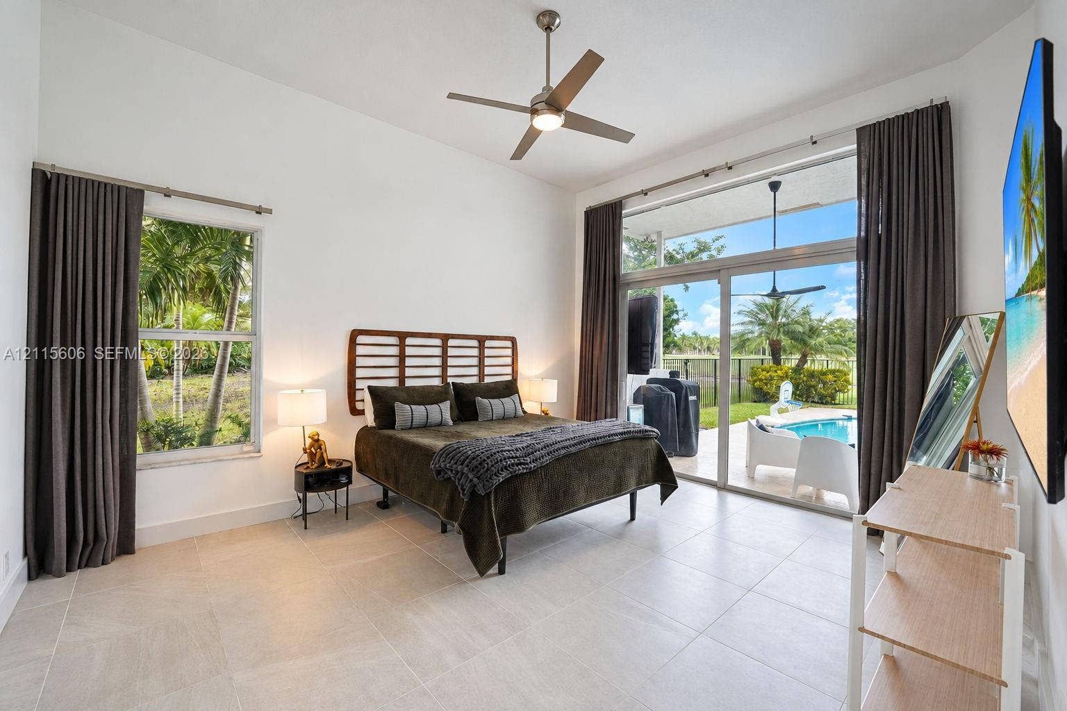 2652 Palmer Place, #2652, Weston, Weston, FL 33332 High ceilings featuring a central ceiling fan, large-format tile flooring, oversized windows, and expansive sliding glass doors