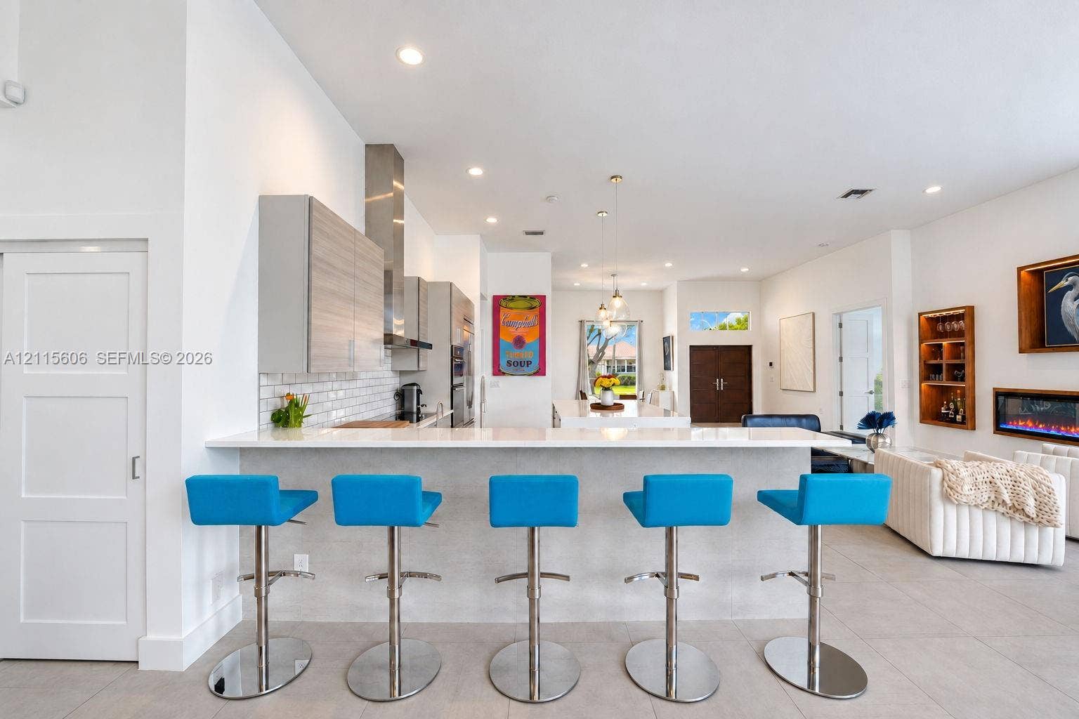 2652 Palmer Place, #2652, Weston, Weston, FL 33332 Kitchen featuring quartz countertops, wood-finish cabinetry, stainless steel range hood, built-in wall oven, and tile backsplash