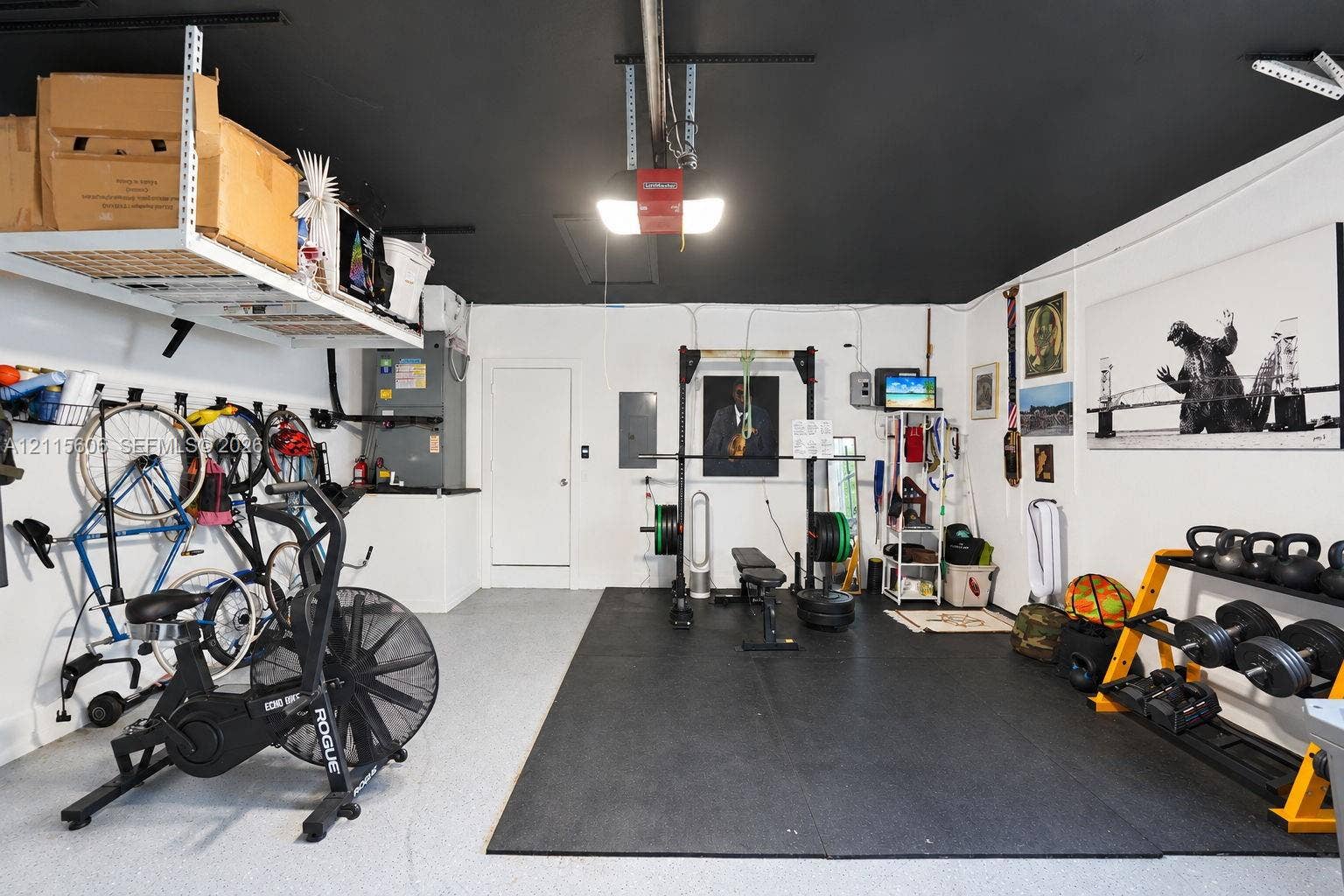 2652 Palmer Place, #2652, Weston, Weston, FL 33332 Garage space featuring epoxy-coated flooring, painted ceiling, and wall-mounted overhead storage shelving