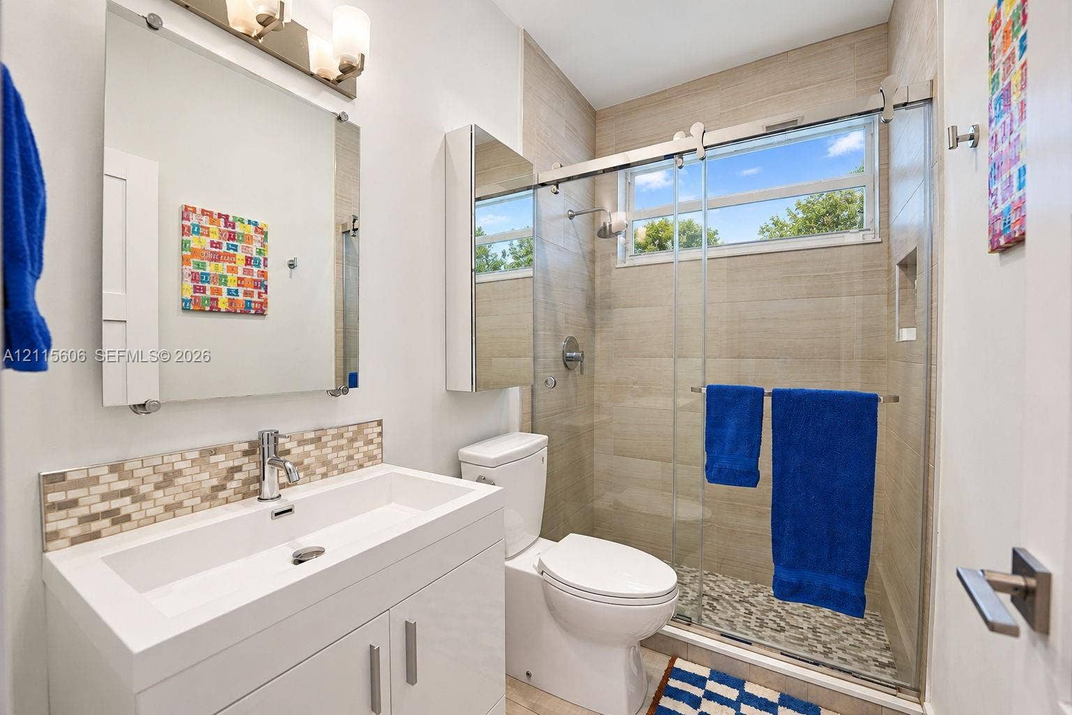 2652 Palmer Place, #2652, Weston, Weston, FL 33332 Modern vanity with rectangular sink and mosaic tile backsplash, frameless glass shower enclosure, horizontal tile shower surround, and integrated wall mirror