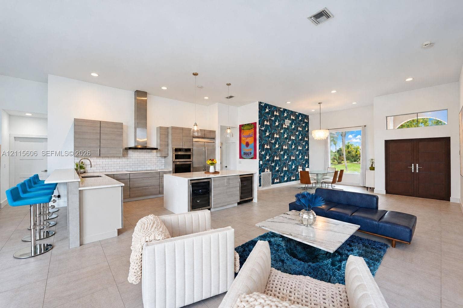 2652 Palmer Place, #2652, Weston, Weston, FL 33332 Open-concept living space featuring a gourmet kitchen with horizontal-grain cabinetry, quartz countertops, a stainless steel chimney-style range hood, and large-format tile flooring