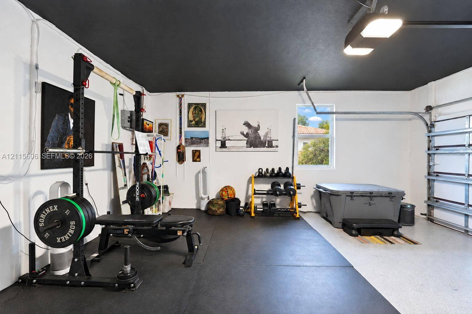 2652 Palmer Place, #2652, Weston, Weston, FL 33332 Garage space featuring high-contrast black ceiling paint, epoxy-coated flooring, and overhead LED lighting